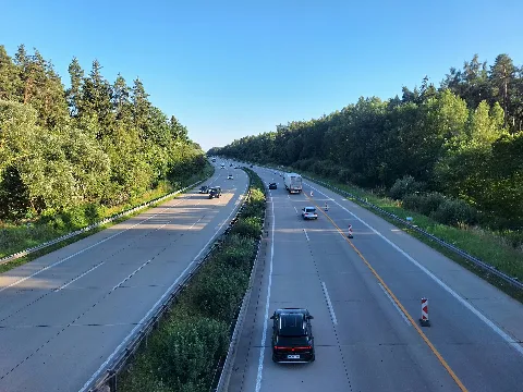 View from the motorway bridge carrying a forest track between Klengel and Bad Klosterlausnitz over the Bundesautobahn 9 (A9) towards the Hermsdorf interchange in the Saale-Holzland district, Thuringia, Germany. At this location, the motorway passes through the extensive forests of the Thuringian Holzland. Temporary roadworks have altered the traffic management on the carriageway. The bridge connects Klengel, a village in the municipality of Serba, with the forest tracks leading towards Bad Klosterlausnitz.