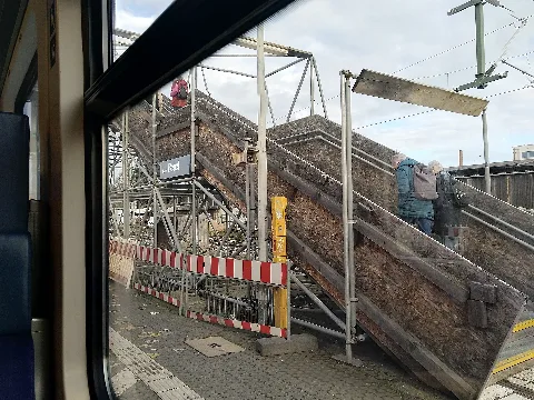 Im Rahmen der Modernisierung des Bahnhofs Bonn-Beuel wurde auch der Mittelbahnsteig umgebaut. Dieser sollte bis 2026 auf einer Länge von rund 400 Metern komplett erneuert werden. Die Bahn (DB) wollte diesen auch erhöhen. Den Anfang machte man mit dem Abbruch des nördlichen Bereichs des Mittelbahnsteigs ab Februar 2024. Seither halten die Züge (laut Planung vorerst bis August 2025) auf Höhe des provisorischen Treppenturms.
