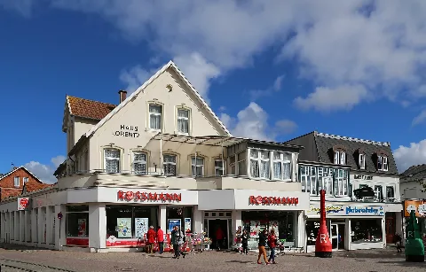Lorentz House (Haus Lorentz, left, with Rossmann shop) and Baldur House (Haus Baldur) at Beach Street (Strandstraße) in the city centre of Borkum, Landkreis Leer, Lower Saxony, Germany.