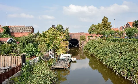 Drainage canal with lock in Ditzum, municipality of Jemgum in East Frisia, Lower Saxony, in northwestern Germany. The drainage water flows into the nearby river Ems. The photo was taken from the so-called Hühnerbrücke (chicken bridge).