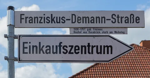 Street name sign of Franziskus Demann Street (Franziskus-Demann-Straße) in the city centre of Freren, Samtgemeinde Freren, Landkreis Emsland, Lower Saxony, Germany.