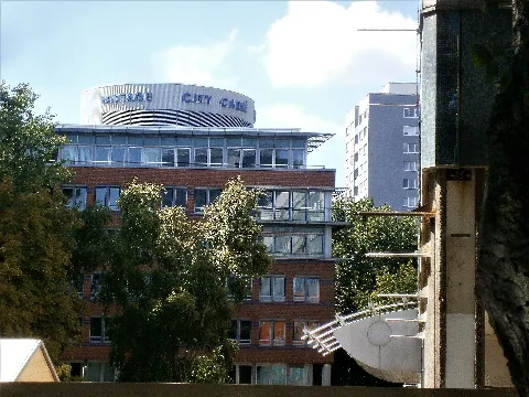 Im Berliner Bezirk Friedrichshain-Kreuzberg, Ortsteil Friedrichshain in der Nähe des Ostbahnhofs. Blick vom östlichen Abschitt der Langen Straße am Hermann-Stöhr-Platz (links) und dem ehemaligen Kaufhaus Galeria Kaufhof, welches 1979 als Centrum-Warenhaus eröffnet wurde entlang. Im Bild das City Carree Ostbahnhof mit der Ecke an der Koppenstraße und der Langen Straße und weiter im Hintergrund das Wohnhochhaus Andreasstraße 20. Das City Carree Ostbahnhof belegt das gesammte Karree zwischen dem Bahnviadukt, der Koppenstraße, der Langen Straße und der Andreasstraße. Die Andreasstraße ist ein Straße im Berliner Bezirk Friedrichshain-Kreuzberg, Ortsteil Friedrichshain zwischen Holzmarkstraße/ Stralauer Platz (nahe Ostbahnhof) und der Karl-Marx-Allee. Die Lange Straße ist für den motorisierten Verkehr mehrfach unterbrochen, so z.B. hier voraus, am Hermann-Stöhr-Platz und Kaufhaus.