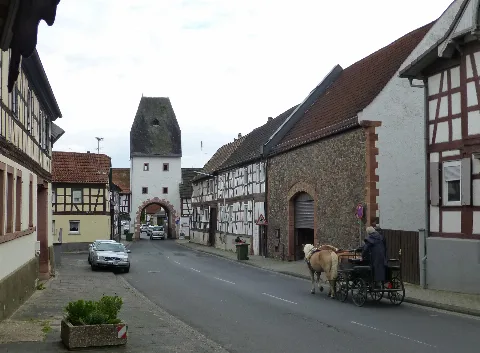 Main street through the Lower Gate Untertor in Marköbel, near Hammersbach, Hessen. Note the horse-drawn cart.