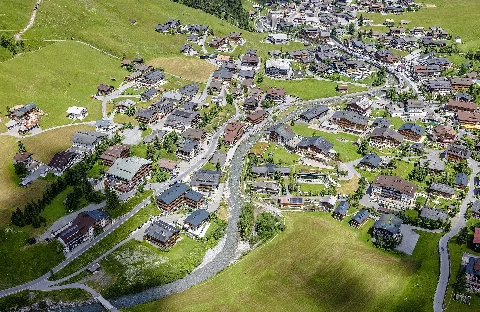 Aerial view of the municipality of Lech, on the left the district of Tannberg (with Schlegelkopfbahn I and II), Lech (river), on the right in the front the district of Omesberg, on the right behind: the center of Lech am Arlberg, Vorarlberg, Austria
