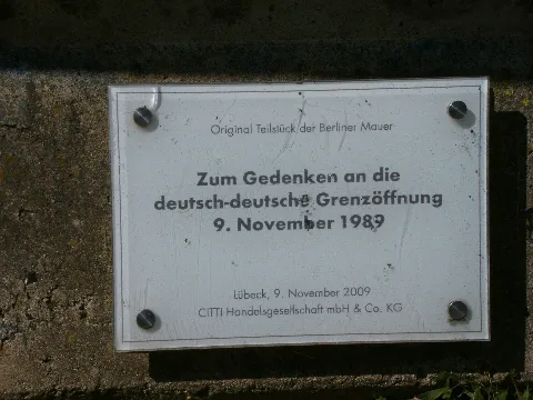 Lübeck-Schlutup, Germany: Documentation house GDR in the Mecklenburger Straße 12. Original segment of the Berlin Wall. Plaque.