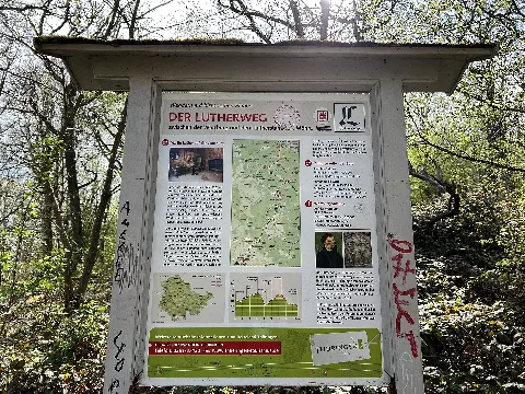 Information board about the Luther Pilgrimage trail near Wartburg Castle in nature reserve "Wälder mit Schluchten zwischen Wartburg und Hohe Sonne" in Thuringia, Germany