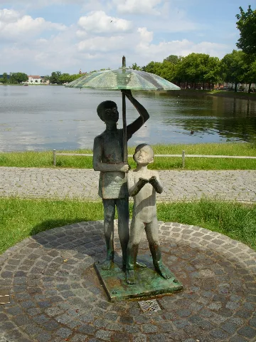 Sculpture Schirmkinder (umbrella children) by Stephan Horota at southern shore of Pfaffenteich in Schwerin, Mecklenburg-Vorpommern, Germany
