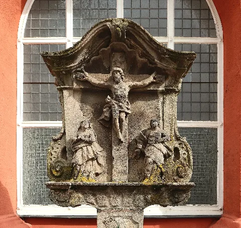 Detail of wayside shrine (18th century) with crucifixion scene at former church St. Martin in Trier-Pfalzel, Germany.