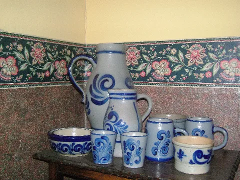 en:Westerwald Pottery or Stoneware is a distinctive type of salt glazed grey pottery from the de:Höhr-Grenzhausen and Hilgert area of Westerwaldkreis in Rhineland-Palatinate, known as Kannenbäckerland. Everyday domestic pottery, bought in Hilgert. Typical swirling blue decoration on grey.
