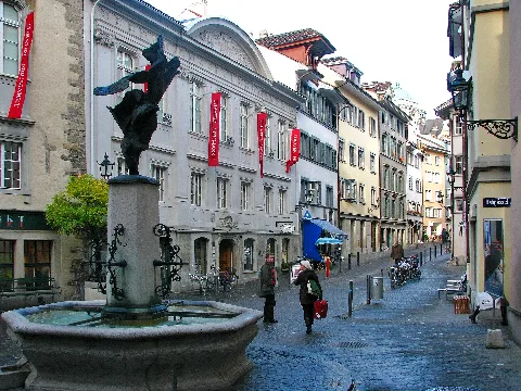 Zürich: Altstadt quarter (Neumarkt) with Bilgeriturm (13th century) and Nike fountain at the left side, and, in the center, Theater am Neumarkt.